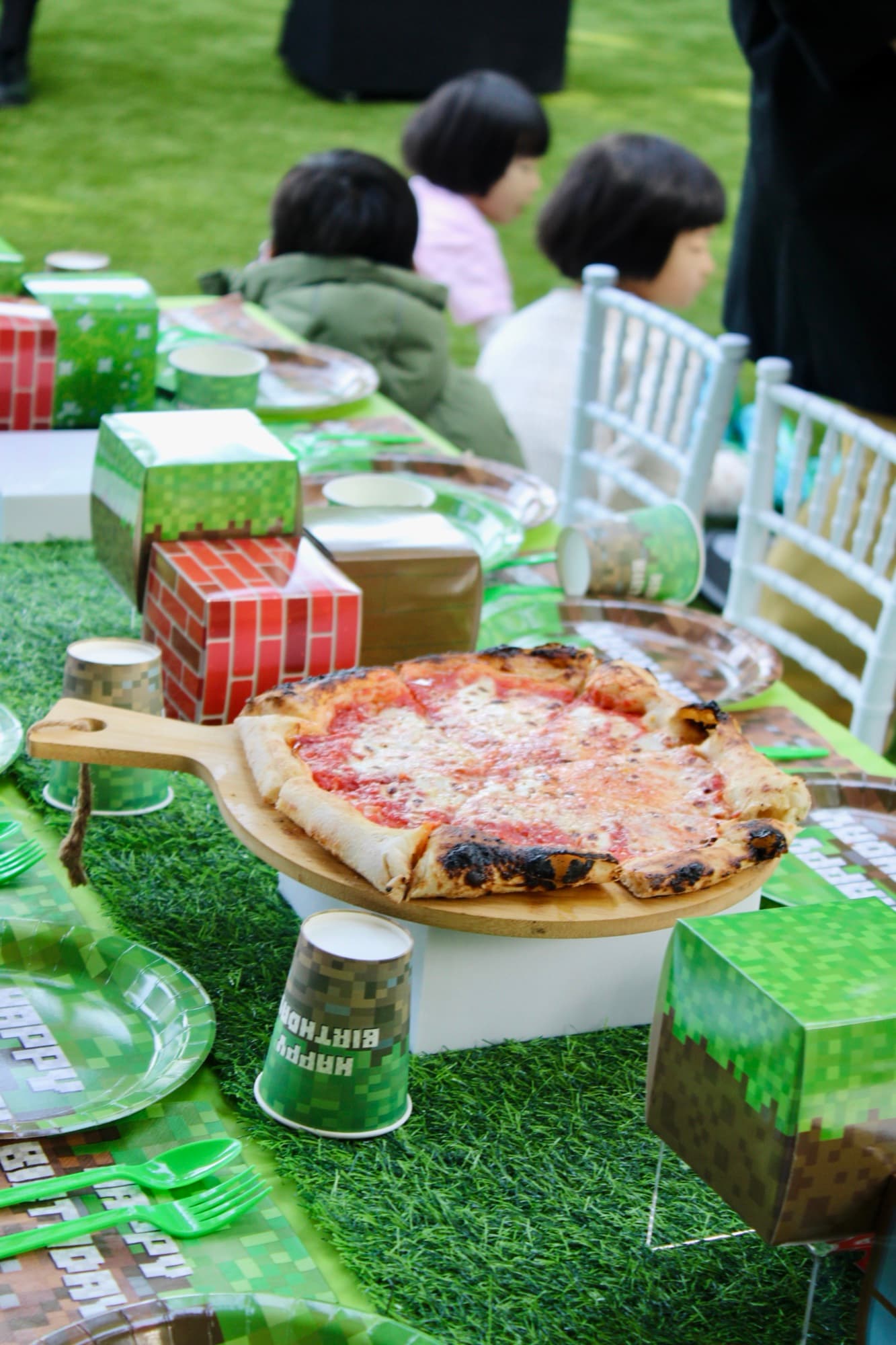 A themed celebration table paired with wood-fired pizza service.
