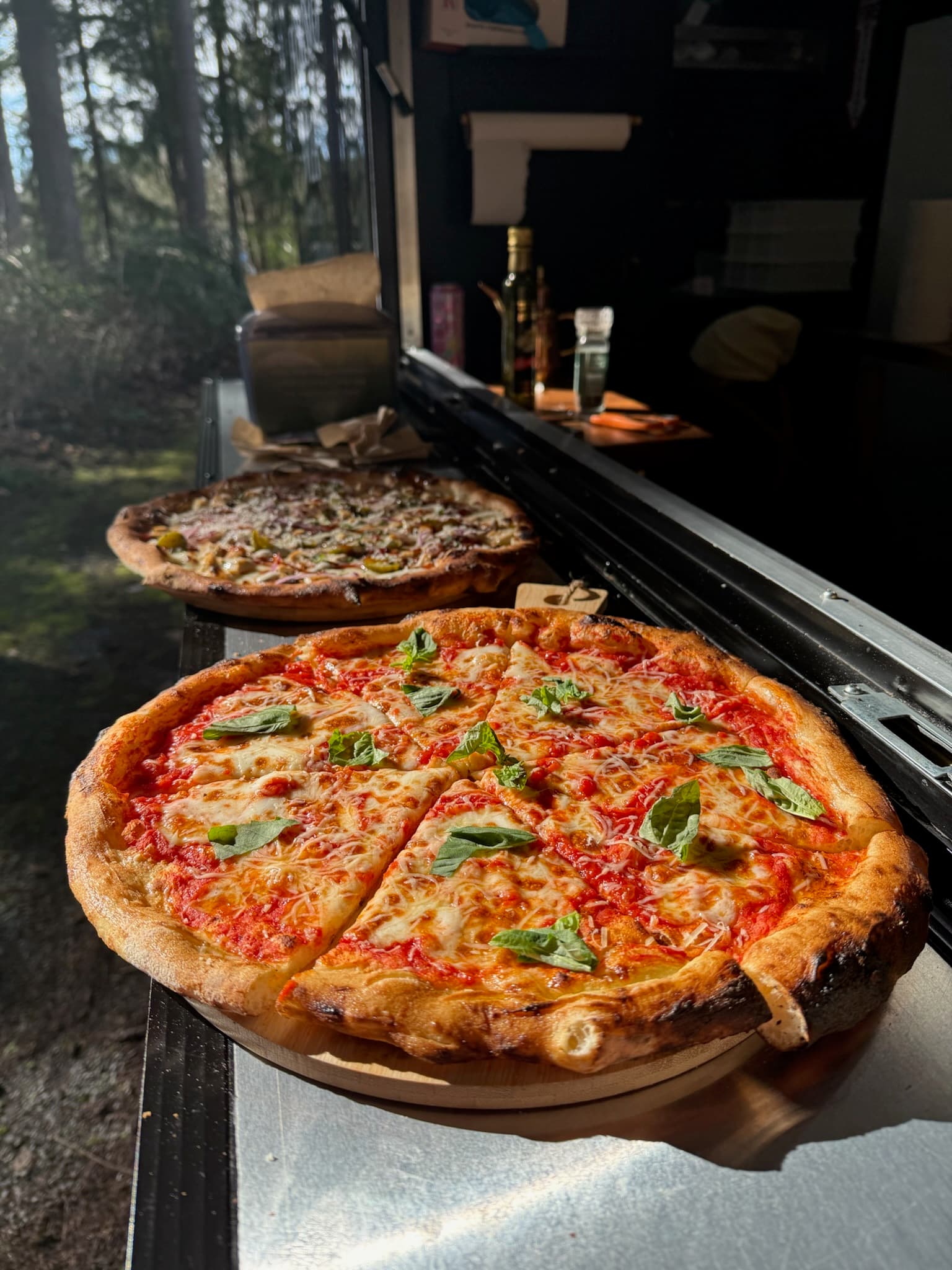 Two freshly baked wood-fired pizzas at the Forno Via trailer