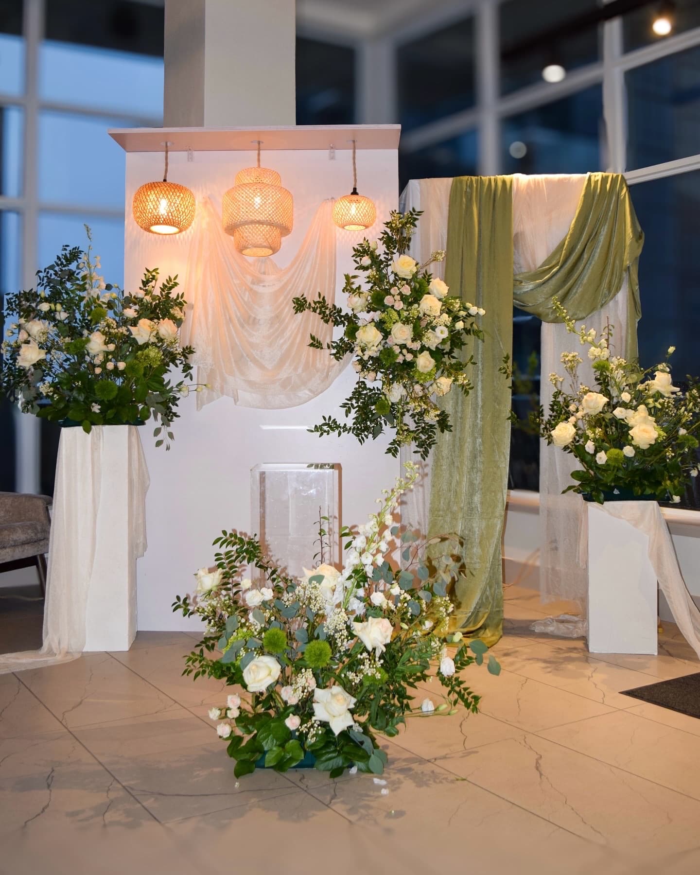 Ceremony florals framing the aisle at a wedding.